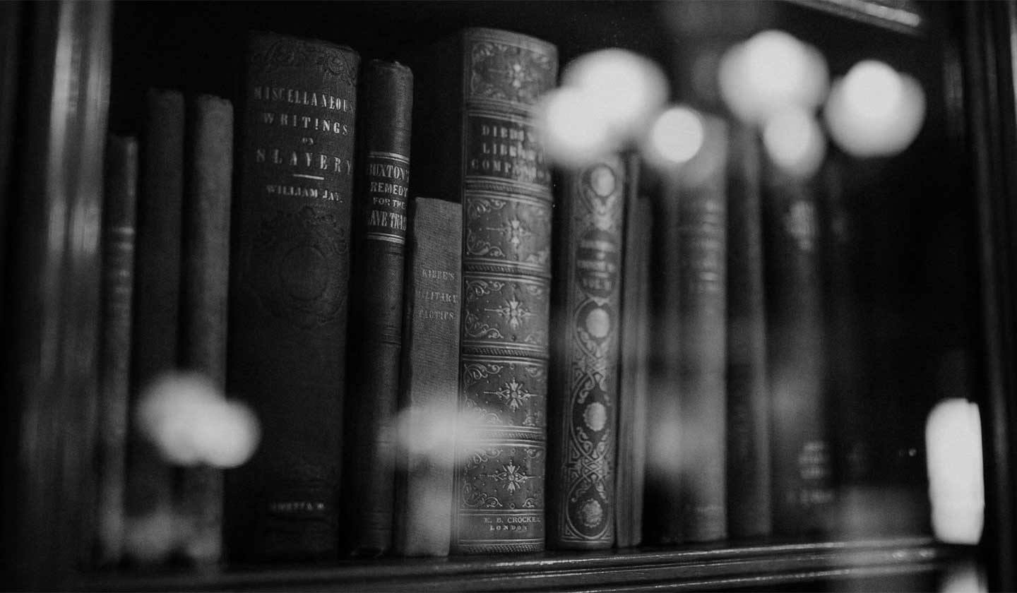 black and white photo of books on a book shelf