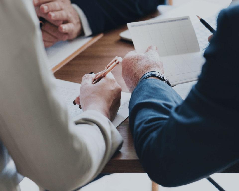 close up photo of two people signing documents